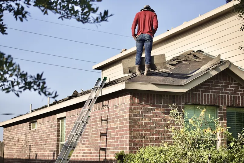 Professional roofer working on a residential roof in Park Place